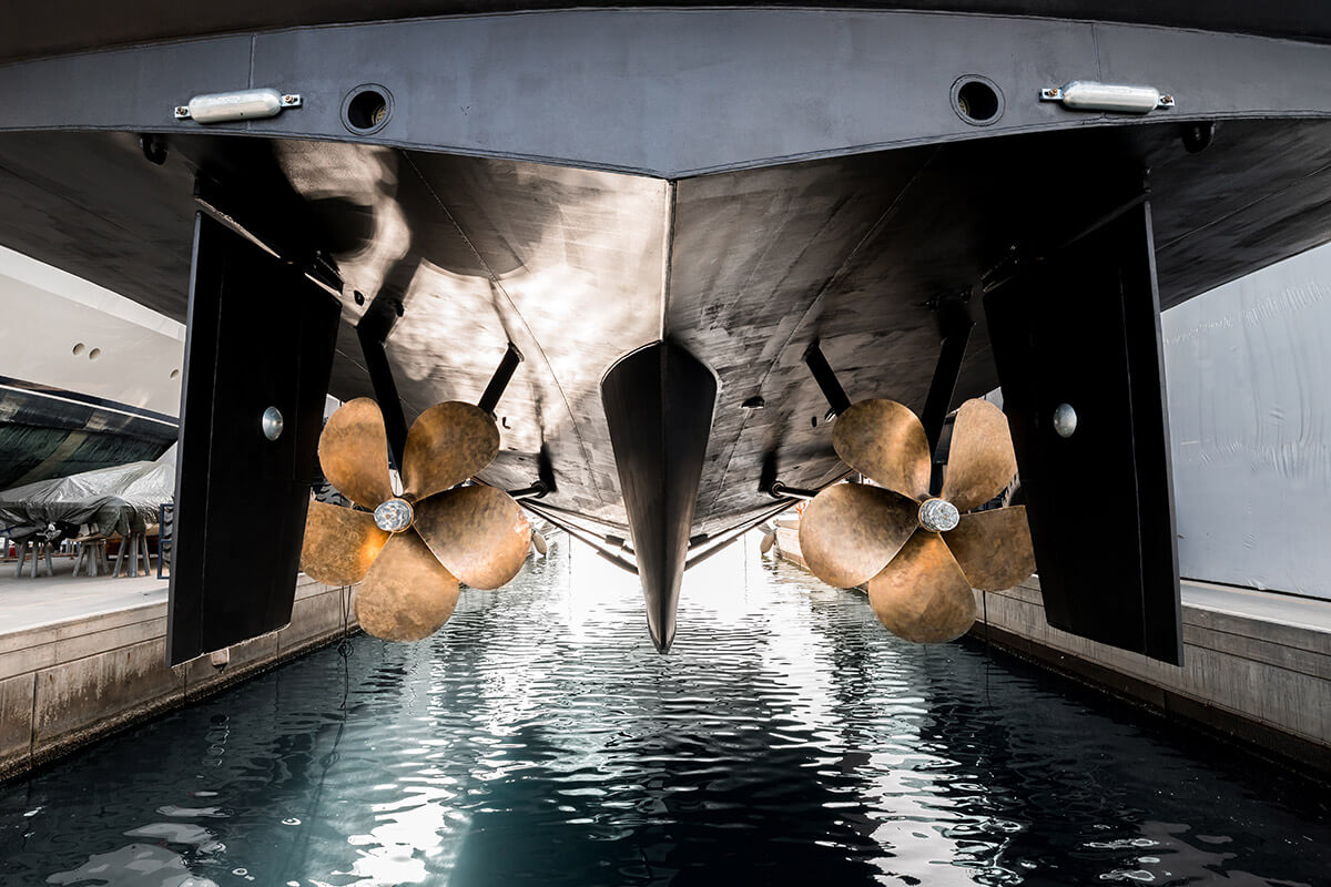 superyacht being lowered into the water after winter haul out at shipyard